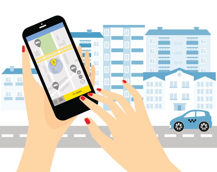 Hand holding cell phone with ride-share app on screen with urban street scene in background