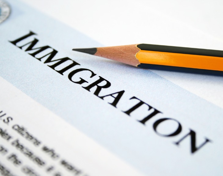 The word Immigration on paper with pencil 