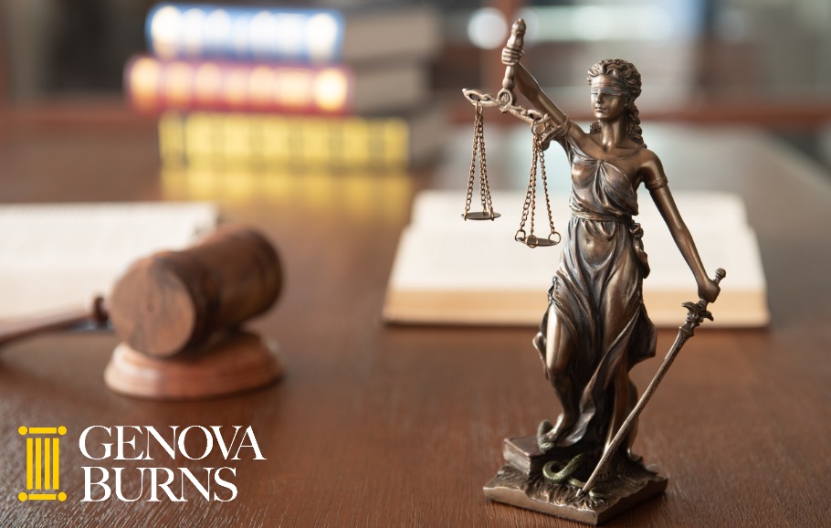 gavel and lady justice statue on desk with stack of books